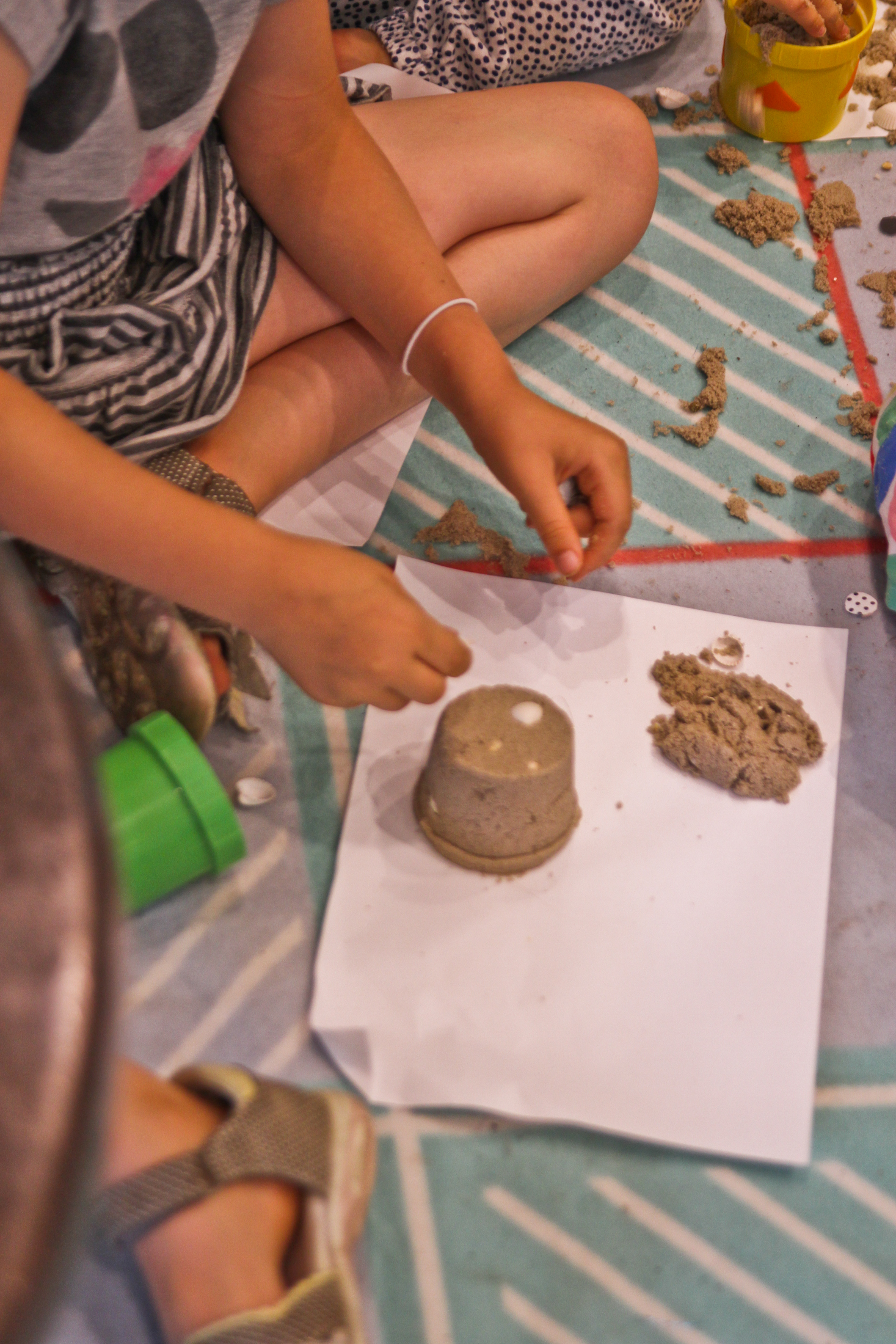 dziecko robiące babki z piasku