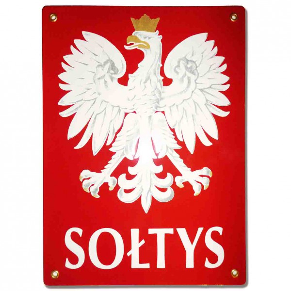Czerwona tablica z orłem z godła polski i pod nim napisem sołtys