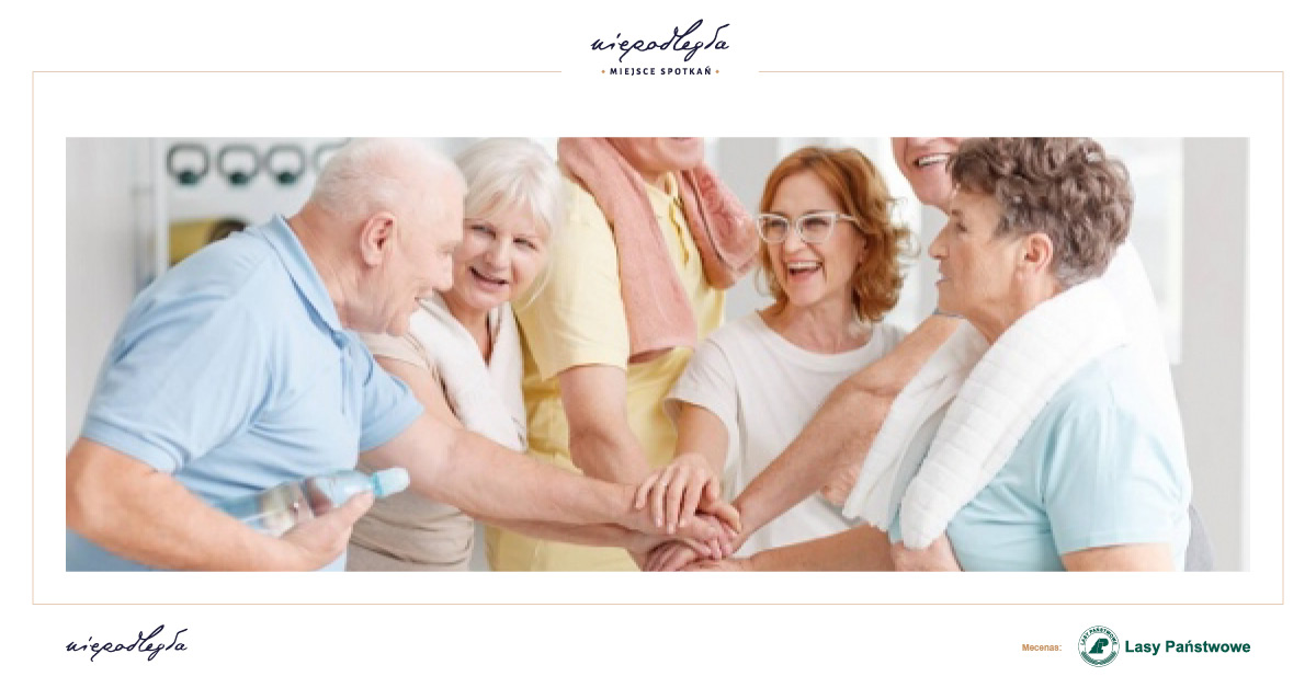 Zdjęcie przedstawia grupę uśmiechniętych osób (seniorek i seniorów).